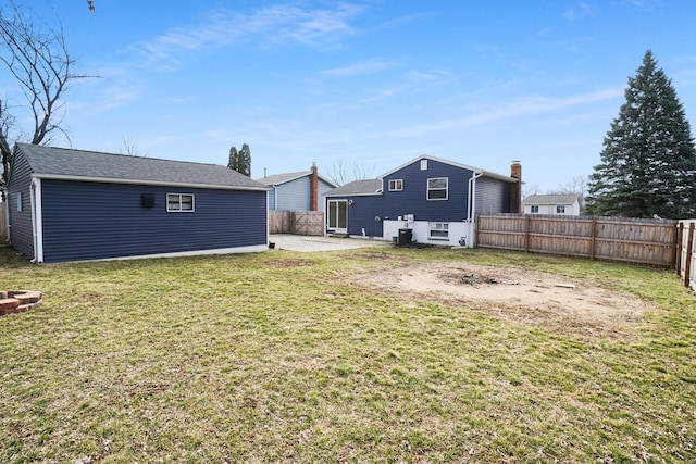 view of yard with a patio, an outdoor structure, and a fenced backyard