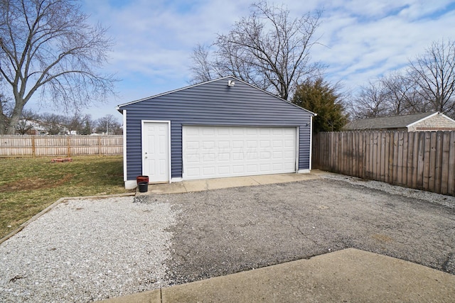 detached garage featuring fence