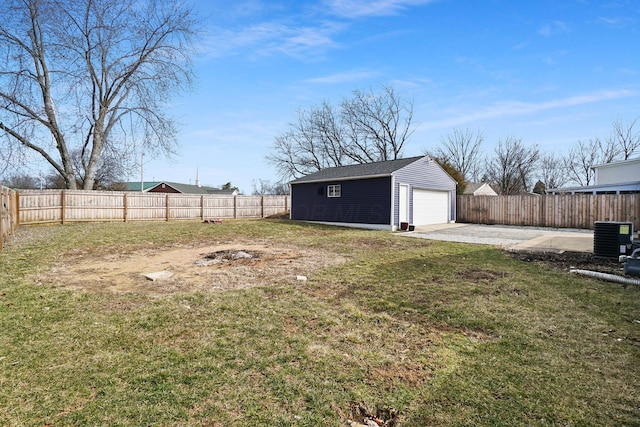 view of yard with a detached garage, central AC unit, a fenced backyard, an outdoor structure, and a patio area