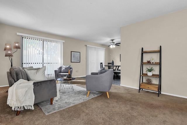 carpeted living room with ceiling fan and baseboards