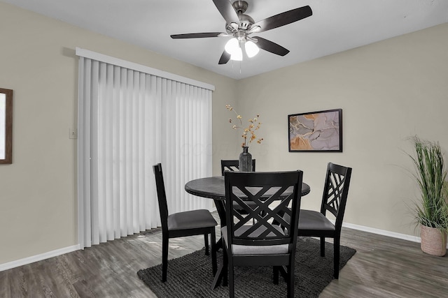 dining space featuring ceiling fan, baseboards, and wood finished floors