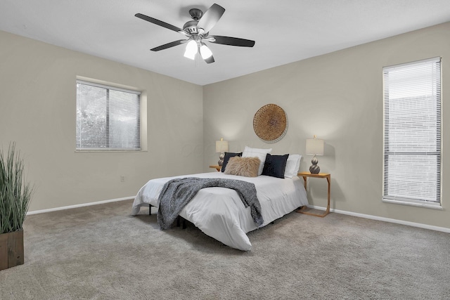 bedroom with carpet floors, multiple windows, and baseboards