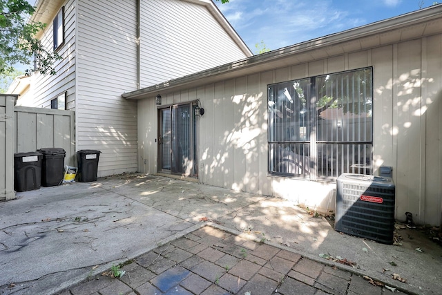 back of property featuring a patio area, fence, and central AC