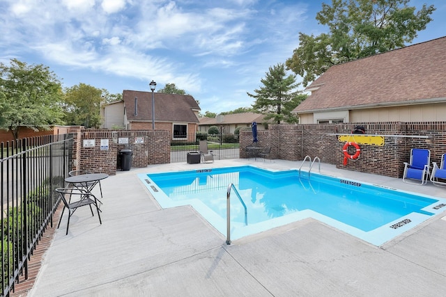 community pool featuring a patio area and fence