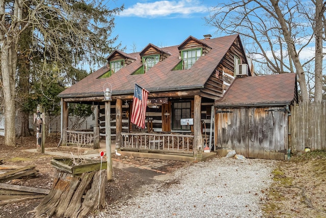 view of front facade with a porch, a chimney, and roof with shingles