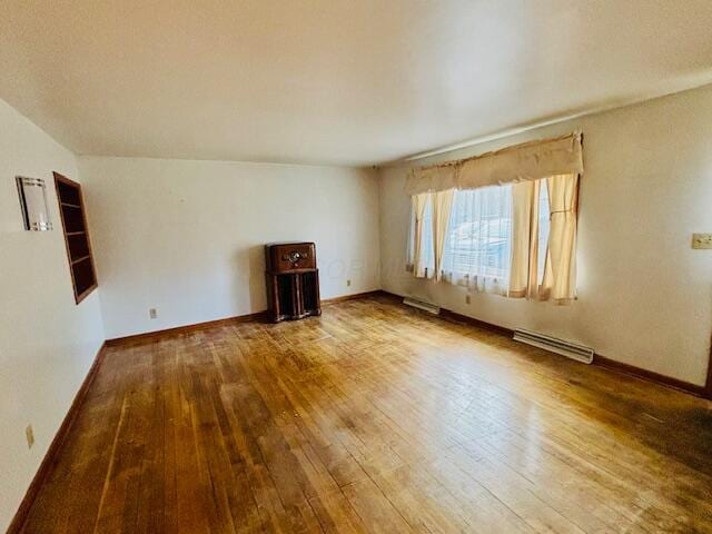 spare room with visible vents, hardwood / wood-style flooring, and baseboards