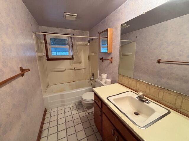 bathroom with visible vents, toilet, tile patterned flooring, vanity, and shower / bathing tub combination