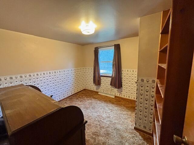 bedroom with wainscoting, carpet flooring, and wallpapered walls