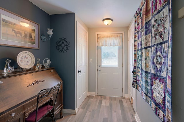 entryway featuring light wood-type flooring and baseboards