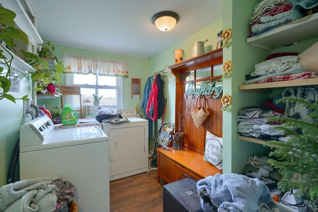 clothes washing area featuring washer and dryer, laundry area, and wood finished floors