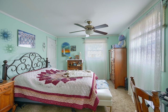 bedroom with light carpet, a ceiling fan, and crown molding