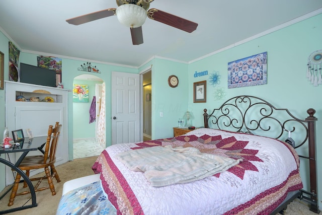 bedroom with arched walkways, carpet floors, ornamental molding, and ceiling fan