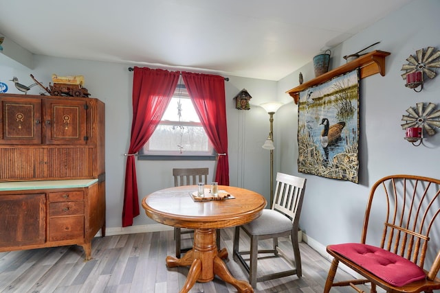 dining area featuring wood finished floors and baseboards