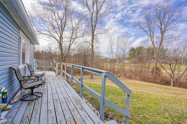 wooden terrace featuring a lawn