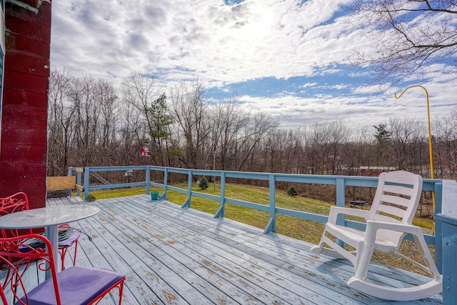 wooden deck with a lawn