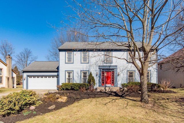 colonial home with a garage and a front yard