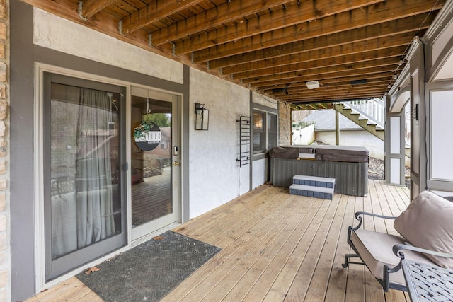 wooden deck featuring a hot tub