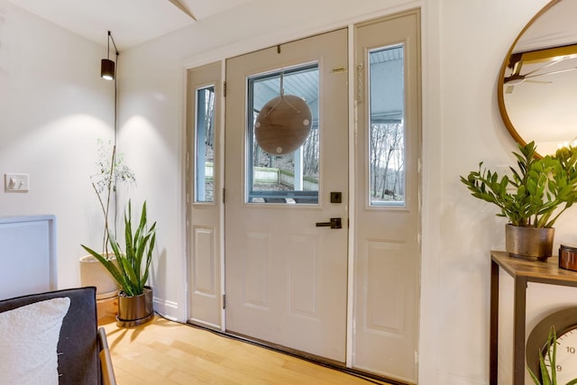 entrance foyer with light wood-style flooring and baseboards