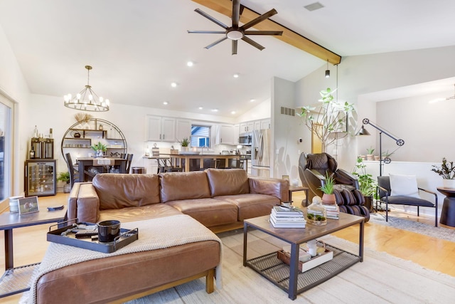 living room with light wood-style floors, recessed lighting, visible vents, and vaulted ceiling with beams