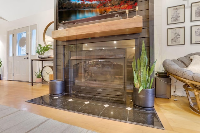 interior details with wood finished floors and a fireplace with flush hearth