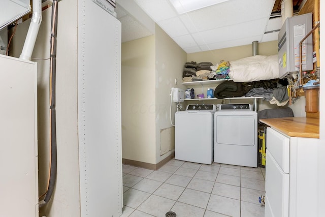 clothes washing area featuring cabinet space, independent washer and dryer, baseboards, and light tile patterned floors