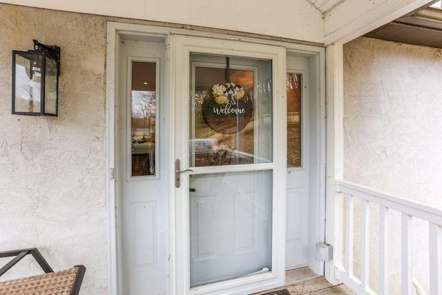 doorway to property with stucco siding