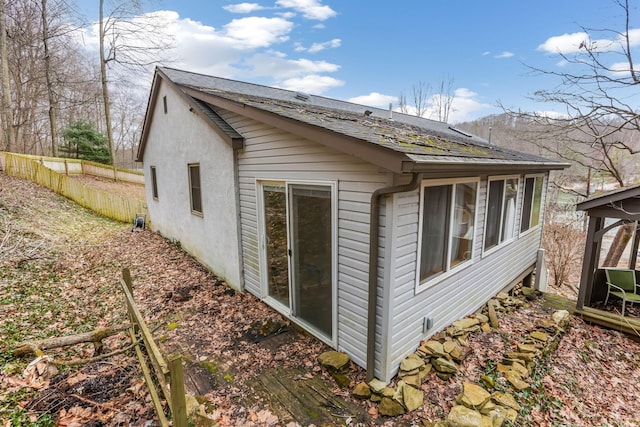 view of side of home with fence