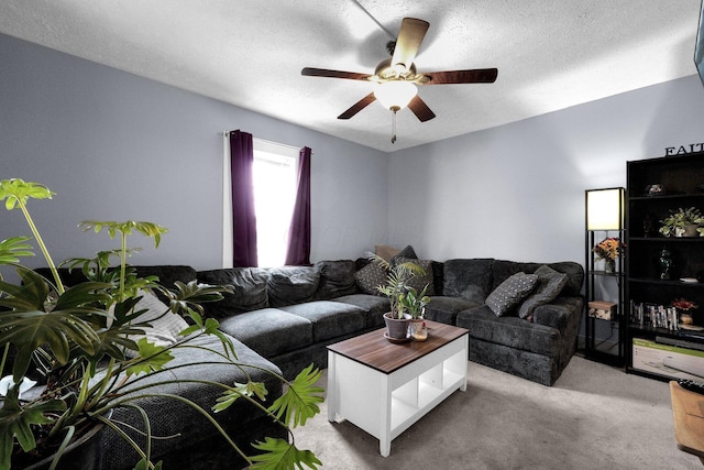 carpeted living room featuring ceiling fan and a textured ceiling