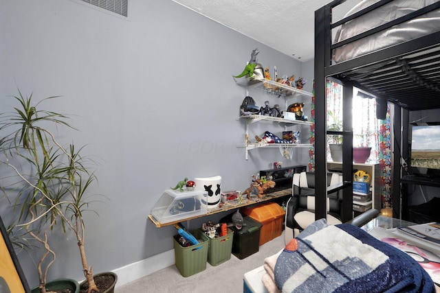 bedroom featuring a textured ceiling, carpet floors, visible vents, and baseboards