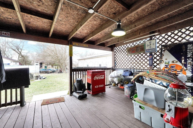 wooden terrace with a lawn