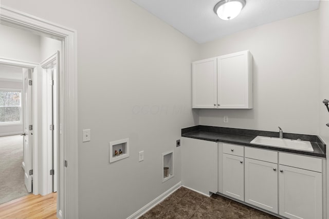 washroom with cabinet space, electric dryer hookup, washer hookup, and a sink