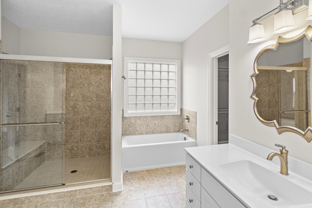 full bathroom with a bath, a stall shower, tile patterned flooring, and vanity