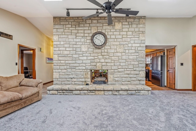 unfurnished living room featuring a ceiling fan, a high ceiling, carpet, and baseboards