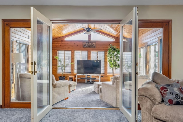 living area featuring a wealth of natural light, french doors, lofted ceiling, and carpet floors