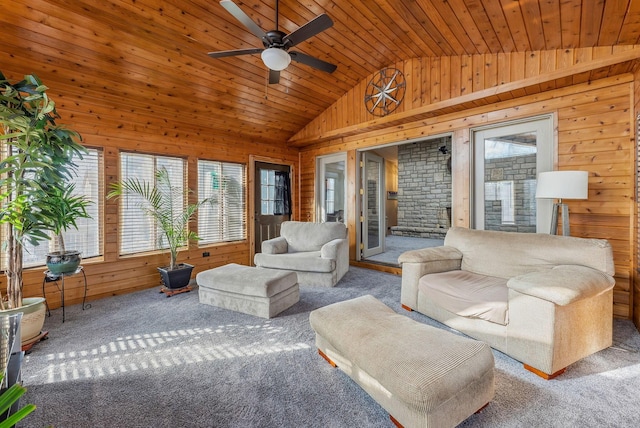 living room with a ceiling fan, vaulted ceiling, wood walls, wooden ceiling, and carpet flooring