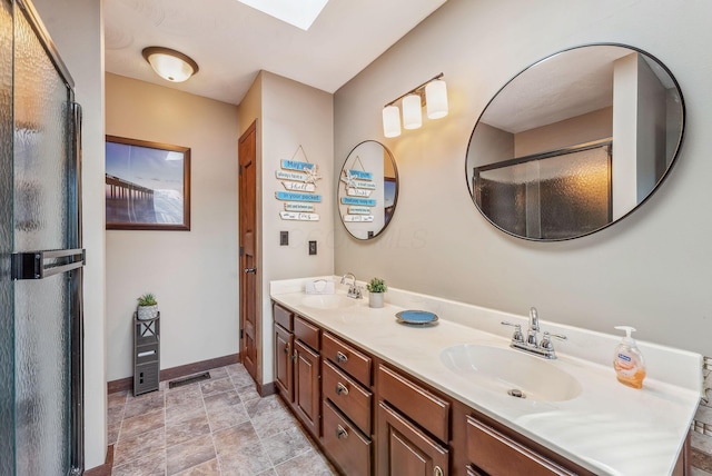 bathroom featuring double vanity, visible vents, baseboards, and a sink