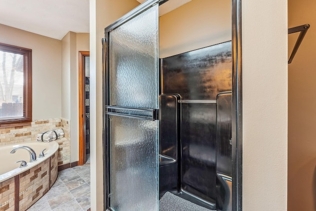 bathroom with a bath and a shower with door