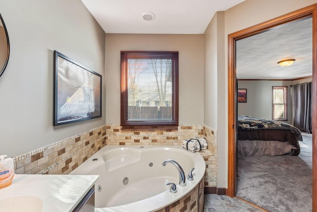 full bathroom with vanity, ensuite bath, and a whirlpool tub