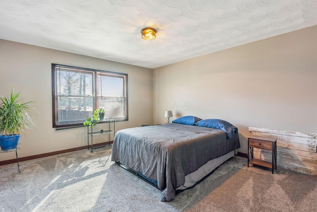 bedroom with baseboards and carpet floors