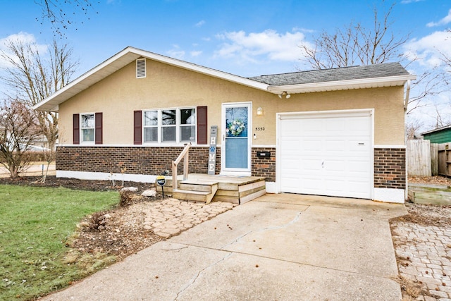 single story home with an attached garage, brick siding, fence, concrete driveway, and stucco siding