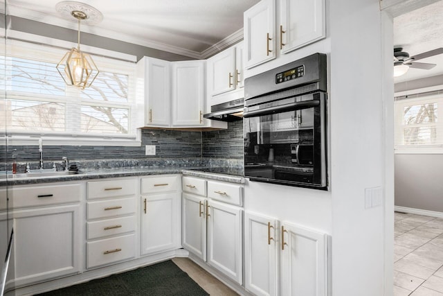 kitchen with a sink, white cabinetry, backsplash, black appliances, and dark countertops