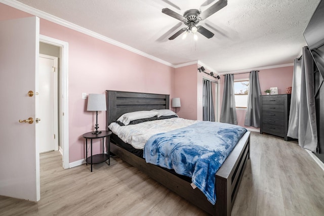 bedroom featuring crown molding, light wood finished floors, ceiling fan, a textured ceiling, and baseboards