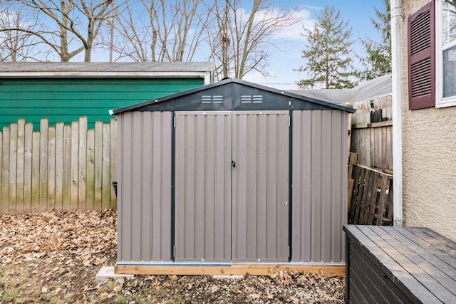 view of shed featuring fence