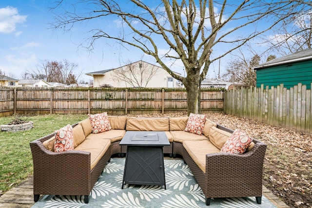 view of patio with an outdoor living space with a fire pit and a fenced backyard