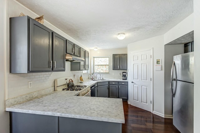 3093 Briar Ridge Rd, Columbus, OH 43232 - kitchen featuring black dishwasher, white gas range oven, freestanding refrigerator, light countertops, and under cabinet range hood