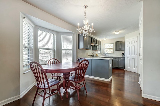 3093 Briar Ridge Rd, Columbus, OH 43232 - dining room featuring a textured ceiling, dark wood-type flooring, an inviting chandelier, and baseboards