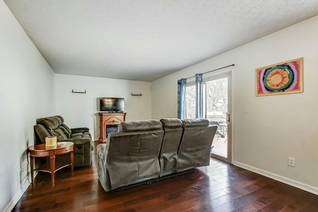 3093 Briar Ridge Rd, Columbus, OH 43232 - living room featuring dark wood-style flooring, a textured ceiling, and baseboards