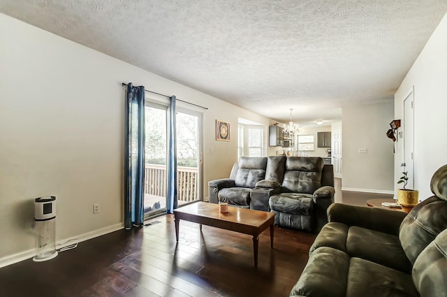 3093 Briar Ridge Rd, Columbus, OH 43232 - living room featuring dark wood-style flooring, visible vents, an inviting chandelier, a textured ceiling, and baseboards