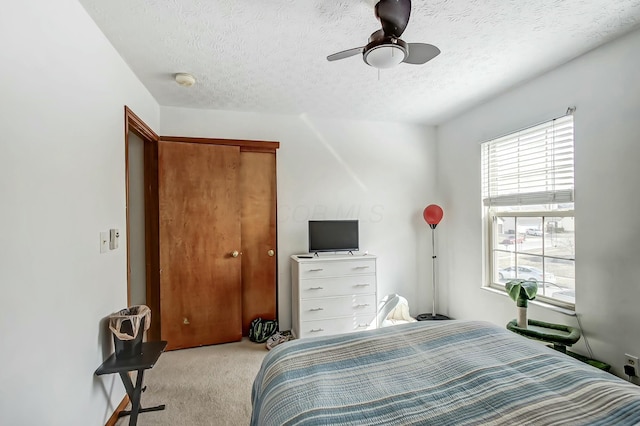 3093 Briar Ridge Rd, Columbus, OH 43232 - bedroom with a textured ceiling, a closet, a ceiling fan, and light colored carpet