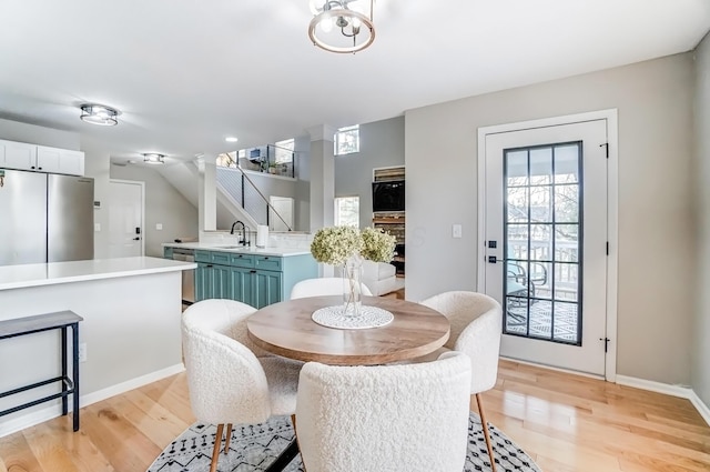 dining room featuring baseboards and light wood-style floors